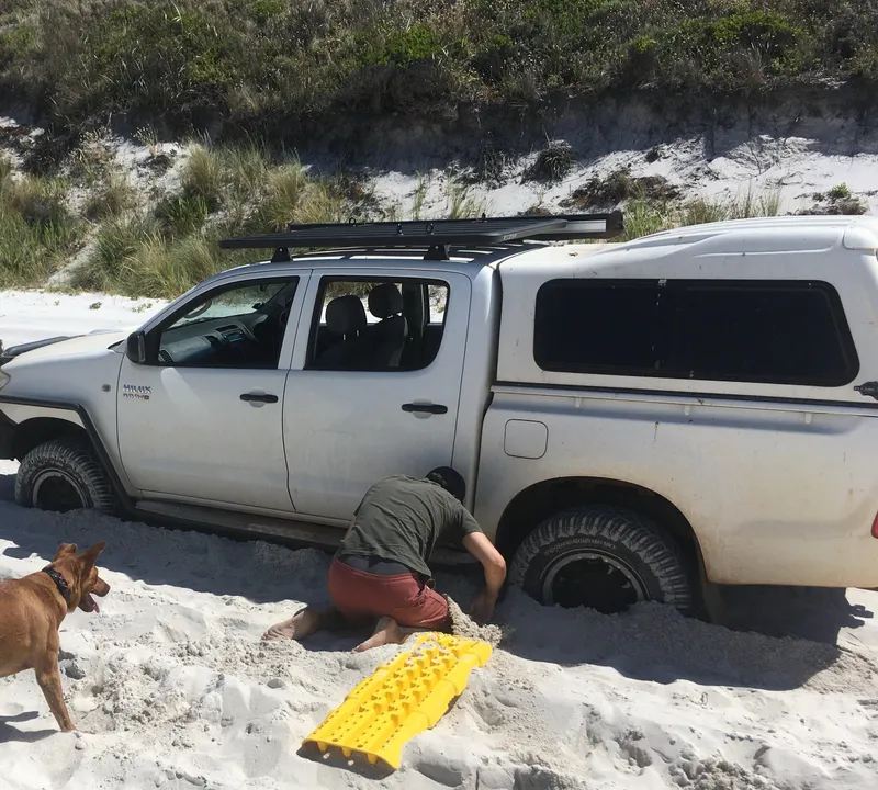 A ute bogged on a beach